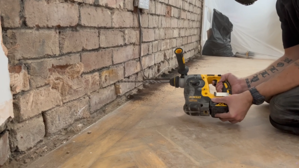 Drilling holes for the dryrods to create a DPC